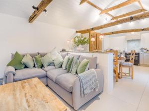 a living room with a couch and a table at The Stables - Uk41887 in Peasmarsh