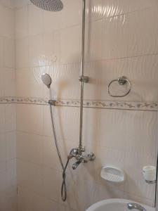 a shower with a shower head in a bathroom at Bethel Resort & Hotels in Gulu