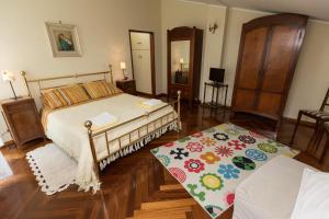 a bedroom with a bed and a rug at Patrian in Grottaferrata