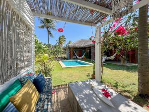 a patio with a bench and a swimming pool at Casa super charmosa com piscina em Icaraizinho! in Icaraí