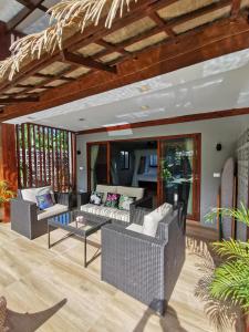 a living room with two couches and a table at Domu Mia Villa Siargao in General Luna