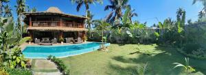 a house with a swimming pool in a yard at Domu Mia Villa Siargao in General Luna