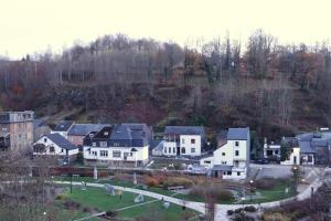 a group of houses on a hill with trees at Le Rêve in La-Roche-en-Ardenne