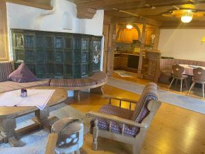 a large living room with couches and a table at Hotel Sonnleiten in Reit im Winkl
