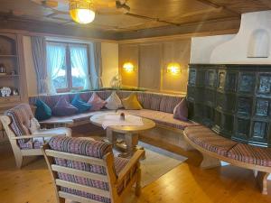 a living room with a couch and a table at Hotel Sonnleiten in Reit im Winkl