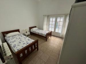 a bedroom with two beds and a window at Sevilla Home Hotel in Buenos Aires