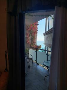 a room with a view of the ocean from a window at Plava Vila Beach Apartments Sveti Stefan in Sveti Stefan