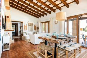 a kitchen and living room with a table and chairs at Lasaienea 4 bedroom villa, Cala Morell in Cala Morell