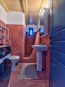 a small bathroom with a sink and a toilet at Nola Traditional Villa with pool and amazing sea views, Paros in Kampos Paros