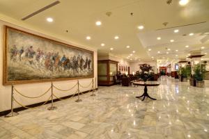 a large painting on the wall in a hotel lobby at Peshawar Serena Hotel in Peshawar