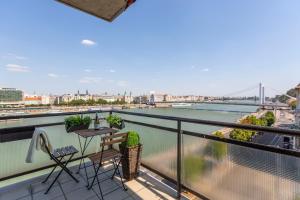 a balcony with a view of a river at Luxury Residence with a Beautiful view for the Danube River in Budapest