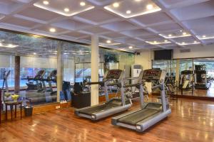 a gym with several tread machines in a room at Peshawar Serena Hotel in Peshawar