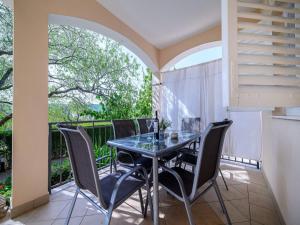 een eetkamer met een tafel en stoelen op een balkon bij Apartman Rokoko in Šibenik