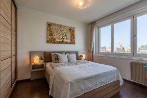 a bedroom with a bed and a large window at Luxury Residence with a Beautiful view for the Danube River in Budapest