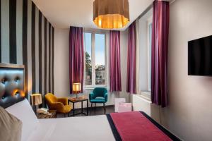 Ліжко або ліжка в номері Navona Colors Hotel
