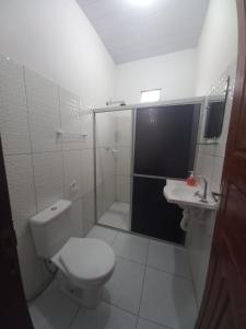 a bathroom with a shower and a toilet and a sink at POUSADA DO BETO in Atins