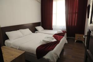 a hotel room with two beds and a window at SALİH BEY KONAĞI in Amasya