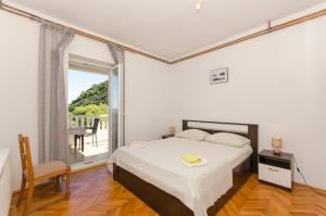 a bedroom with a bed and a large window at Apartment Ruza in Sobra