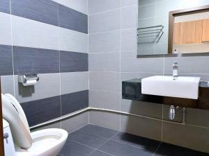 a bathroom with a white toilet and a sink at KSL D'Esplanade Apartment Suites by SC Homestay in Johor Bahru