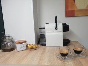 a coffee maker and two glasses of coffee on a counter at By the beach in Calpe +31 photos