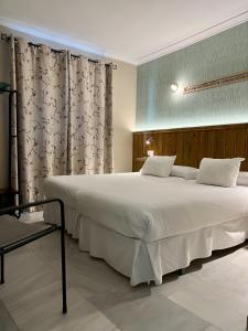 Postel nebo postele na pokoji v ubytování Alameda Hostal Boutique