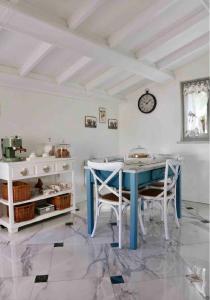 a dining room with a blue table and chairs at Casa Buditto in Orvieto