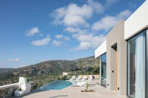 a house with a view of a pool and mountains at Villa Anasa in Palaiochóra