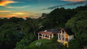 a house on top of a hill with trees at Casa Varuna - 3 Bedrooms in West End