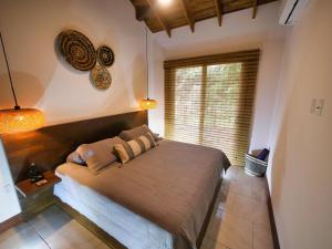 a bedroom with a large bed with a window at Casa Varuna - 3 Bedrooms in West End