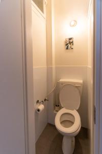 a small bathroom with a toilet and a roll of toilet paper at Ziv Apartments - Hayarkon 196 in Tel Aviv