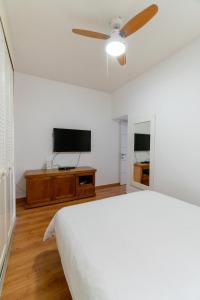 a bedroom with a bed and a flat screen tv at Ziv Apartments - Hayarkon 196 in Tel Aviv