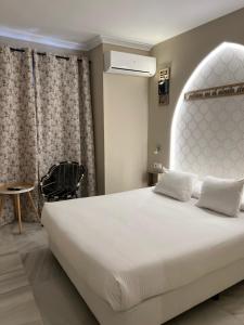 Postel nebo postele na pokoji v ubytování Alameda Hostal Boutique