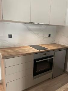 a kitchen with a counter top and a stove at October Luxury Apartments in Ioannina