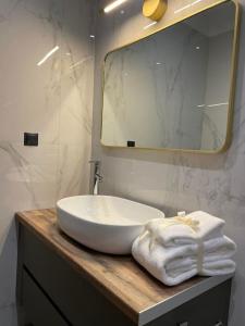 a bathroom with a white sink and a mirror at October Luxury Apartments in Ioannina