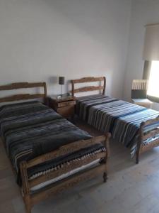 Ένα ή περισσότερα κρεβάτια σε δωμάτιο στο Casa Villa General Belgrano