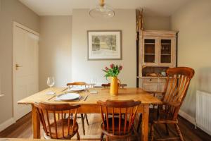 a dining room with a wooden table and chairs at Bell Cottage in Alfriston