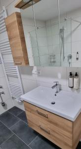 a bathroom with a sink and a mirror at Flat11 4-Zi Wohnung Messe Karlsruhe in Rheinstetten +17 photos