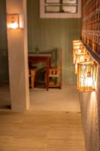 a row of benches in a room with a light at EcoCharme Pousada Varandinha in Fernando de Noronha +15 photos