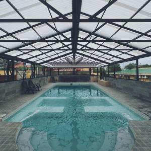 a large swimming pool with a large roof at Hotel Algarrobo in Merlo +25 photos