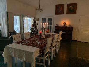 a dining room with a table and a christmas tree at Riverside Home near Santa Claus Village - beautiful house in a prime location in Rovaniemi