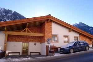 a building with a car parked in front of it at Alkira in Sankt Anton am Arlberg