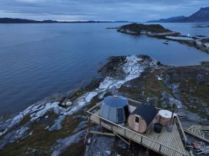 eine Insel mit einem Zelt neben dem Wasser in der Unterkunft Aurora Hut by InukTravel in Nuuk