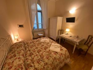 1 dormitorio con cama, mesa y ventana en Relais Del Duomo, en Florencia