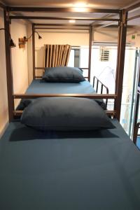 two beds in a room with two pillows on it at THE JOYS HOSTEL in Ho Chi Minh City