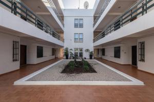 an empty corridor in a building with a courtyard at Hopstays - Vilamoura Aldeia do Mar in Quarteira