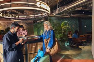 a woman standing next to a man with luggage at The Social Hub Madrid in Madrid