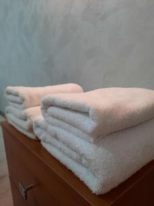 a pile of towels sitting on top of a dresser at PerfectHotel in Myrhorod