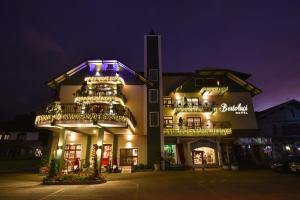 a building with balconies and lights on it at night at Hotel Bertoluci in Gramado