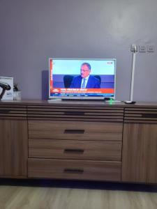 a flat screen tv sitting on top of a dresser at Erzurum DAMAK GRUP in Erzurum