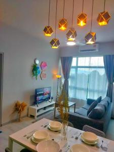 ein Wohnzimmer mit einem Tisch und einem blauen Sofa in der Unterkunft MLH Designer Suites @ Jesselton Quay CityPads in Kota Kinabalu
